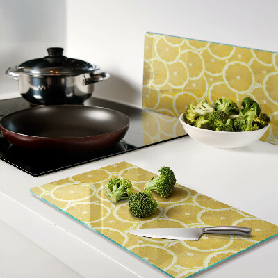Glass kitchen board Lemon slices on a yellow background