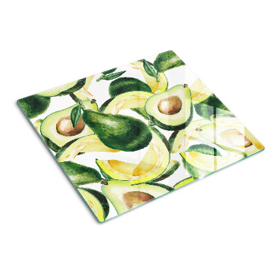 Glass kitchen board Avocado on a background of leaves
