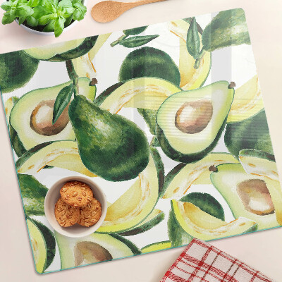 Glass kitchen board Avocado on a background of leaves