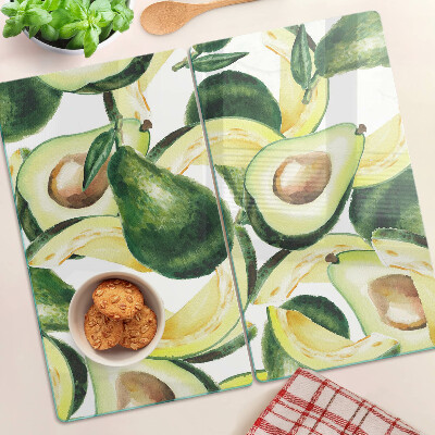 Glass kitchen board Avocado on a background of leaves