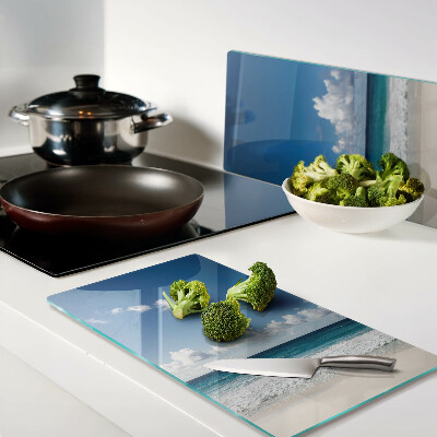 Glass kitchen board Beach with turquoise water and clouds