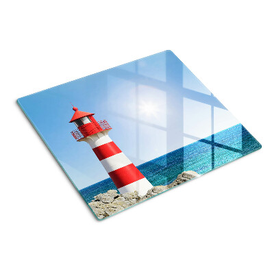 Glass kitchen board Lighthouse over the ocean
