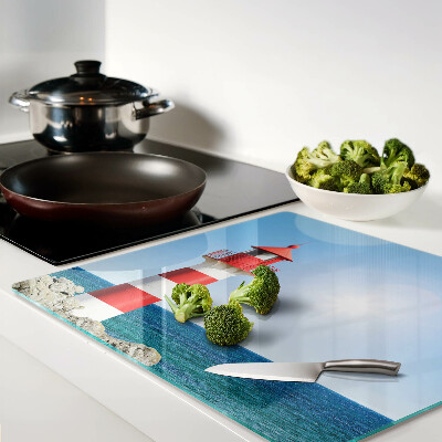 Glass kitchen board Lighthouse over the ocean