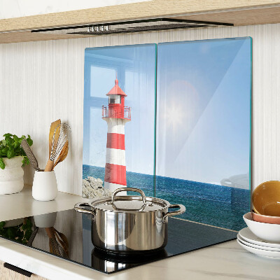 Glass kitchen board Lighthouse over the ocean