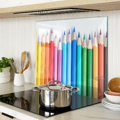 Glass chopping board Colored pencils in a row