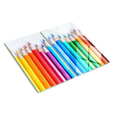 Glass chopping board Colored pencils in a row