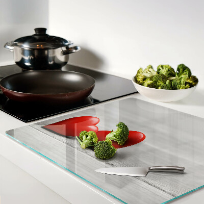 Glass chopping board Red hearts on a wooden background