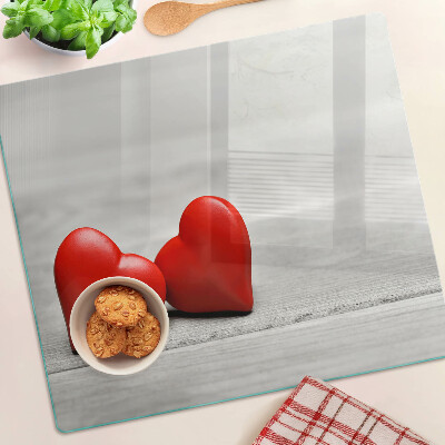 Glass chopping board Red hearts on a wooden background