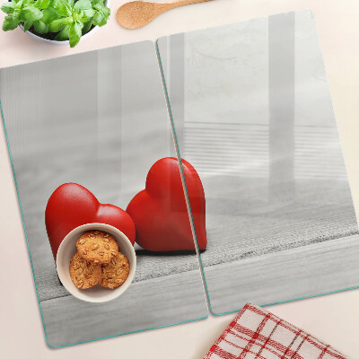 Glass chopping board Red hearts on a wooden background