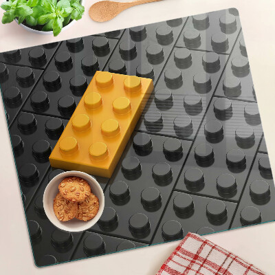 Glass chopping board LEGO bricks on a black background