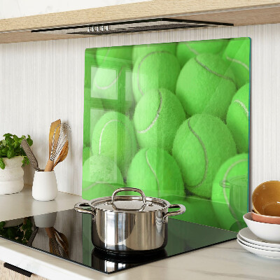 Glass chopping board Tennis balls on a green background