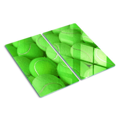 Glass chopping board Tennis balls on a green background