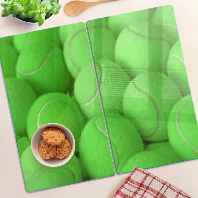 Glass chopping board Tennis balls on a green background