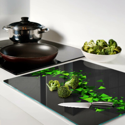 Glass kitchen board Green triangles on a black background