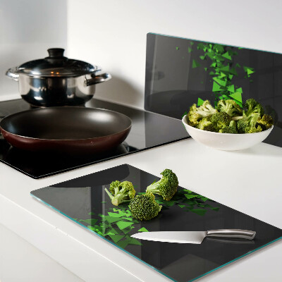 Glass kitchen board Green triangles on a black background