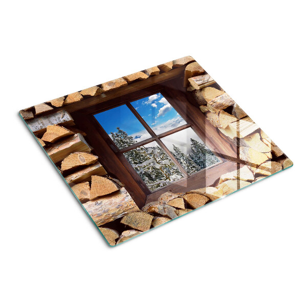Glass chopping board View of a winter landscape through the window