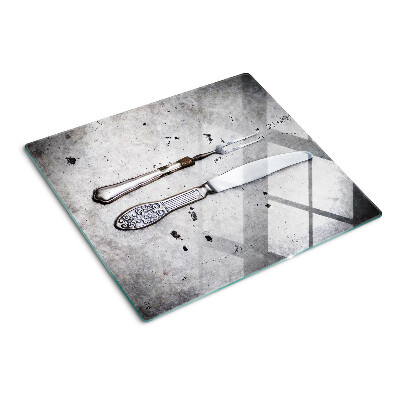 Glass kitchen board Cutlery on a concrete background