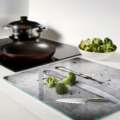 Glass kitchen board Cutlery on a concrete background