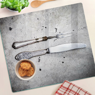 Glass kitchen board Cutlery on a concrete background