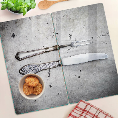 Glass kitchen board Cutlery on a concrete background
