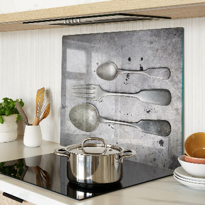 Glass chopping board Cutlery on a concrete background