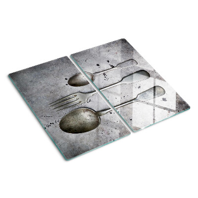 Glass chopping board Cutlery on a concrete background
