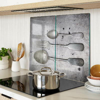 Glass chopping board Cutlery on a concrete background