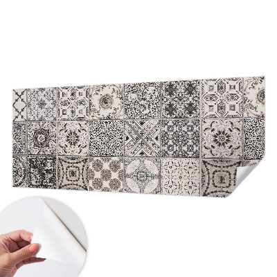 Self-adhesive wall mural featuring tile patterns