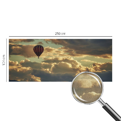 Nursery wall mural with a balloon drifting among the clouds