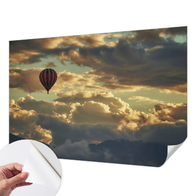 Nursery wall mural with a balloon drifting among the clouds