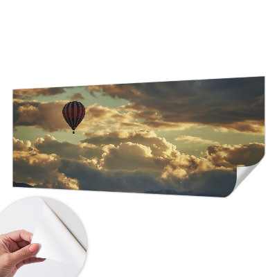 Nursery wall mural with a balloon drifting among the clouds