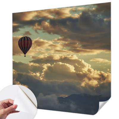 Nursery wall mural with a balloon drifting among the clouds
