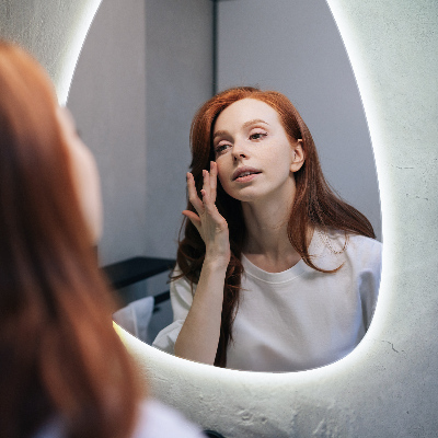 Organic egg-shaped mirror with a backlight feature for wall mounting