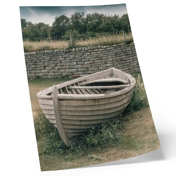 Decorative poster featuring an abandoned boat on a tranquil grassy shore