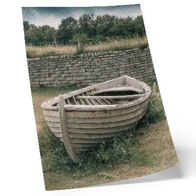 Decorative poster featuring an abandoned boat on a tranquil grassy shore