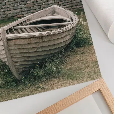 Decorative poster featuring an abandoned boat on a tranquil grassy shore