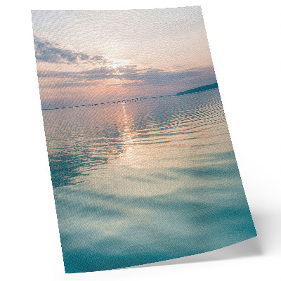 Poster Calm water surface, warm colors of the sky, bridge