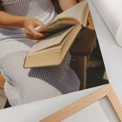 Premium wall art woman with a book on a wooden bench in the sunlight