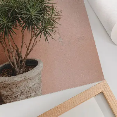 Poster green plant against a peach wall background