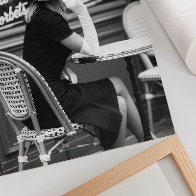 Art print A woman wearing a hat at a table in a cafe