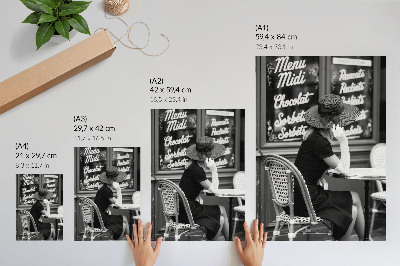 Art print A woman wearing a hat at a table in a cafe