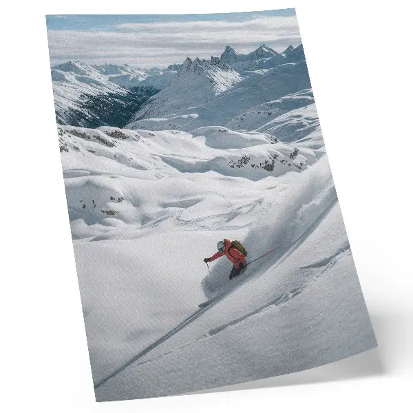 Premium wall art skier in action in the white mountains under a blue sky