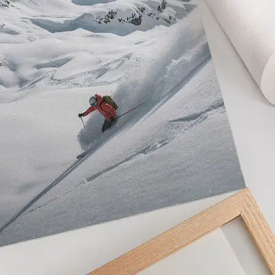 Premium wall art skier in action in the white mountains under a blue sky