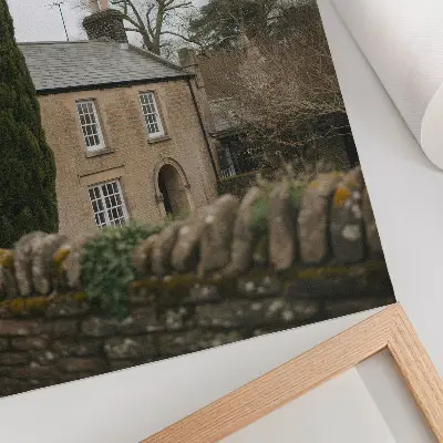 Premium wall art depicting a warm house, trees, and a stone fence in a peaceful atmosphere