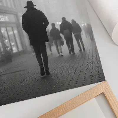 Decorative poster figure in a hat standing in the fog with umbrellas creating a mysterious scene