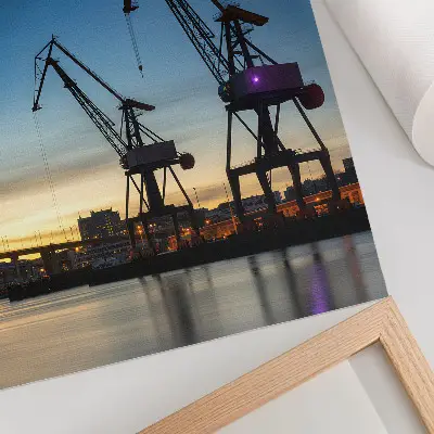 Poster cranes against a dynamic sunset backdrop