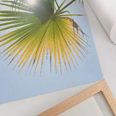 Poster palm leaves on a blue background with sunlight