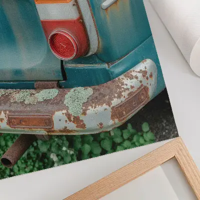 Decorative poster car covered in moss and rust in a turquoise color