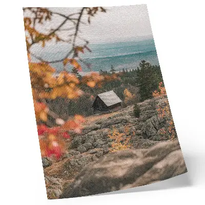 Decorative poster a house on a rock among trees in peaceful autumn nature