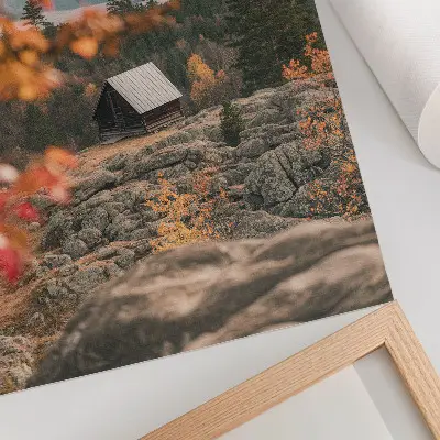 Decorative poster a house on a rock among trees in peaceful autumn nature